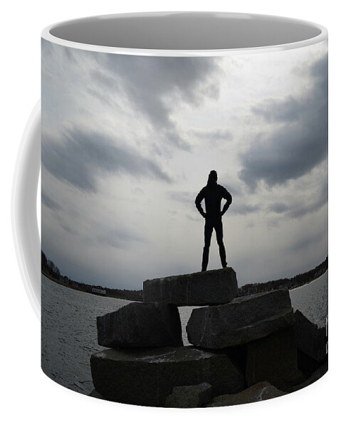Silhouette Coffee Mug featuring the photograph Guy Silhouetted in a Super Hero Pose on a Rock Jetty by DejaVu Designs