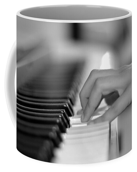 Playing Piano Coffee Mug featuring the photograph Hand on piano keyboard by Serena King