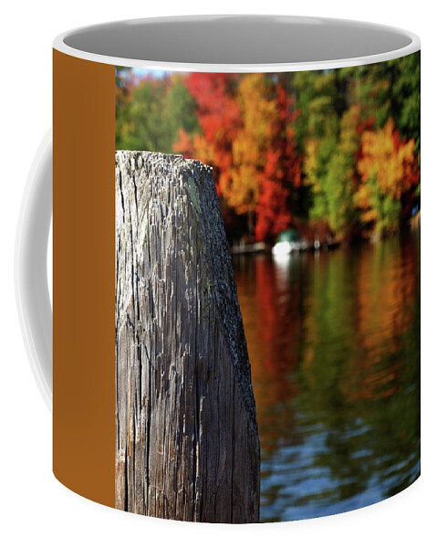 Foliage Coffee Mug featuring the photograph Lake Winnepesaukee dock with Foliage in the Distance by Mary Capriole