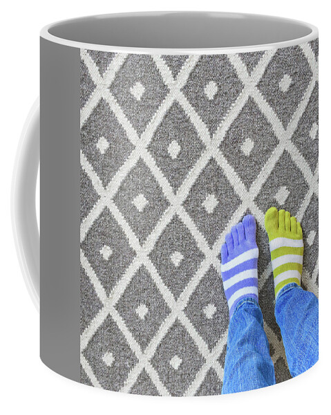 Legs Coffee Mug featuring the photograph Legs in mismatched socks on gray carpet by GoodMood Art