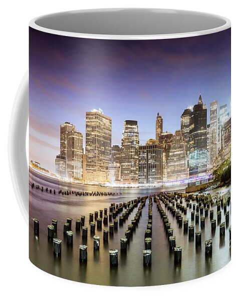 New York Coffee Mug featuring the photograph Lower Manhattan skyline reflected in the East river at dusk, New by Matteo Colombo