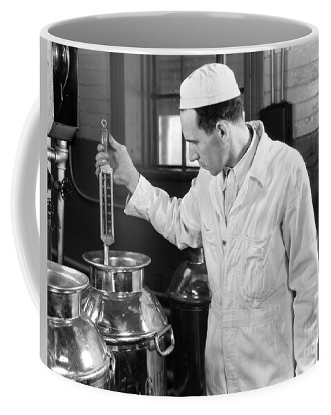 1930s Coffee Mug featuring the photograph Man Checking Milk Temperature, C.1930s by H. Armstrong Roberts/ClassicStock
