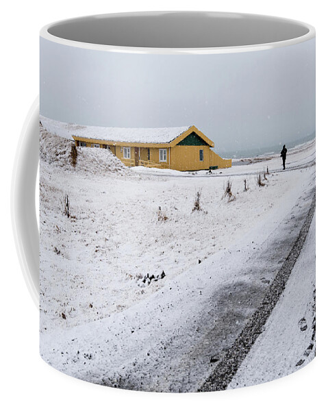 Iceland Coffee Mug featuring the photograph Man walking in snow Iceland by Michalakis Ppalis