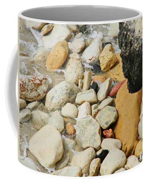  Multi Colored Beach Rocks Are Washed In A Wave At The Ocean Edge Coffee Mug featuring the photograph multi colored Beach rocks by Priscilla Batzell Expressionist Art Studio Gallery