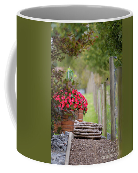 Country Coffee Mug featuring the photograph Red flowerd with Fende and wood billet bundle by Amanda Mohler