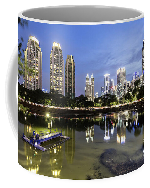Indonesia Coffee Mug featuring the photograph Reflection of Jakarta business district skyline during blue hour by Didier Marti