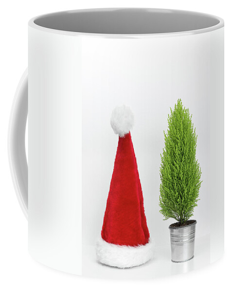 Santa Hat Coffee Mug featuring the photograph Santa hat and little Christmas tree by GoodMood Art