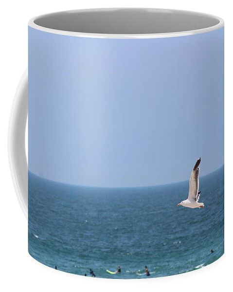 Seagull Coffee Mug featuring the photograph Seagull Flying over Huntington Beach by Colleen Cornelius