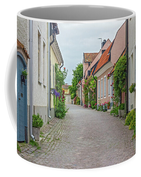 Street Coffee Mug featuring the photograph Street with old houses in a Swedish town Visby by GoodMood Art