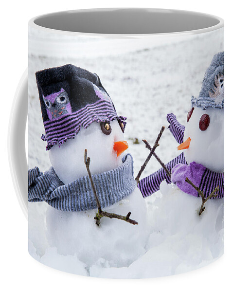 Snowmen Coffee Mug featuring the photograph Two cute snowmen friends embracing by Simon Bratt
