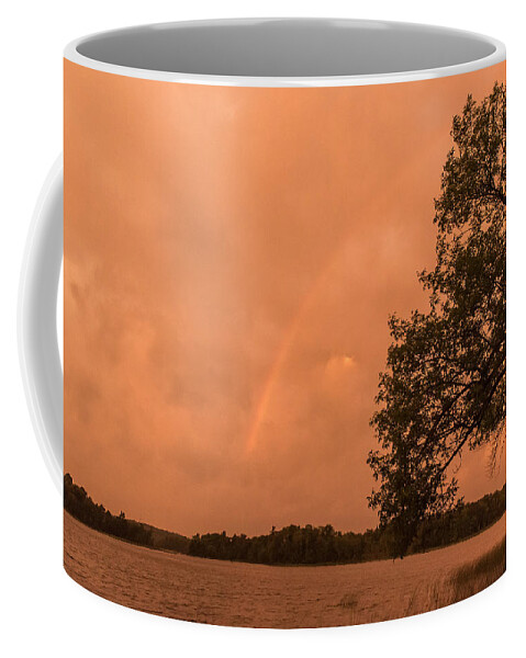 Orange Dawn Coffee Mug featuring the photograph Strange orange sunrise with rainbow by Gary Eason