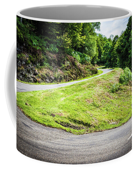 Boussenac Coffee Mug featuring the photograph Winding road with sharp bend going up the mountain by Semmick Photo
