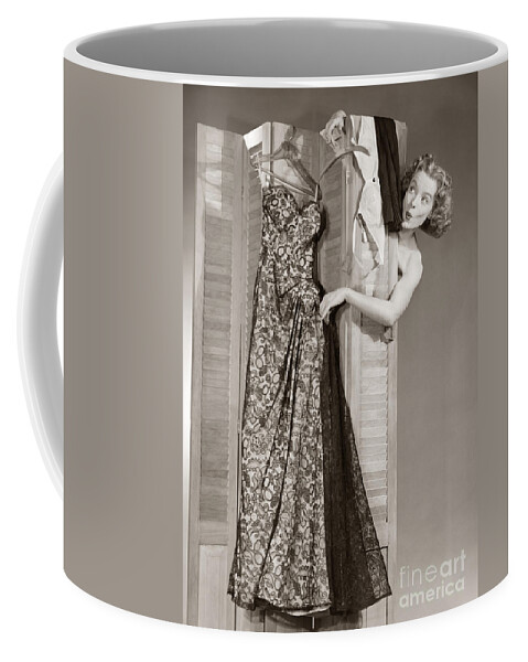 1950s Coffee Mug featuring the photograph Woman Reaching Around Screen For Dress by Debrocke/ClassicStock