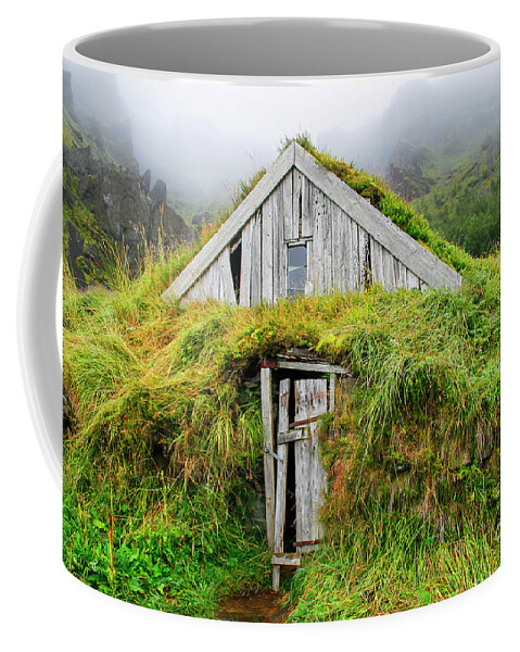 Iceland Coffee Mug featuring the photograph Wooden house isolated with grass in Iceland by Patricia Hofmeester