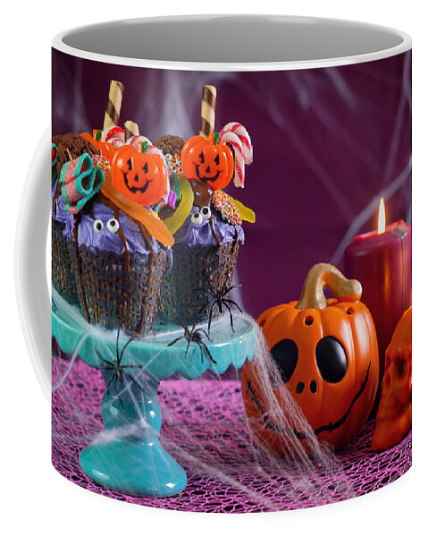 Halloween Coffee Mug featuring the photograph Halloween candyland drip cake style cupcakes in party table setting. #1 by Milleflore Images