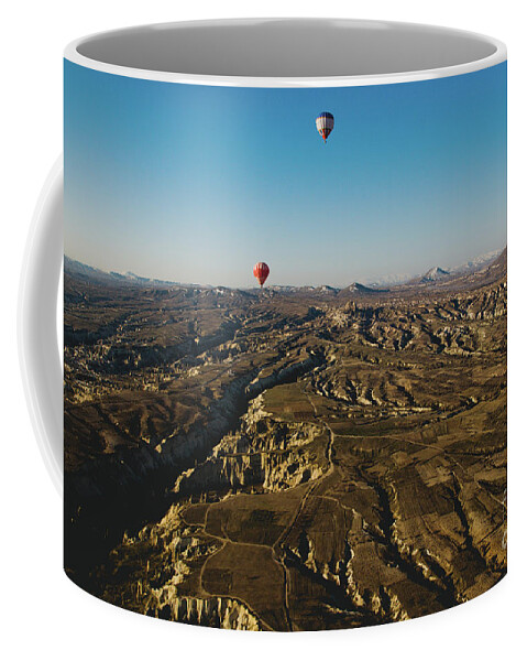 Adventure Coffee Mug featuring the photograph Colorful balloons flying over mountains and with blue sky #6 by Joaquin Corbalan