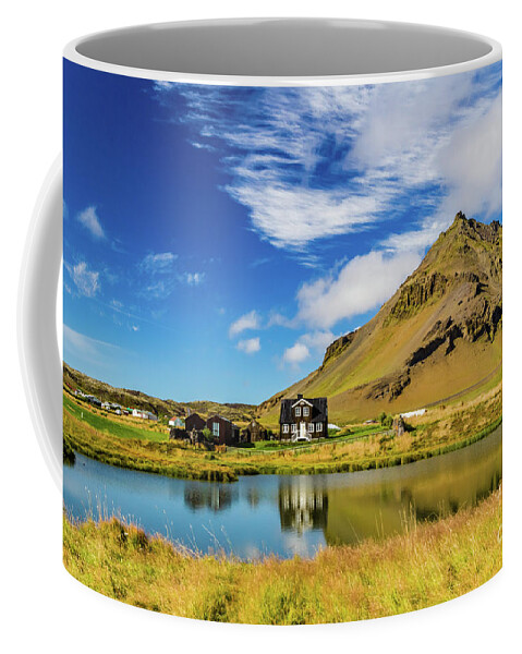 Arnarstapi Coffee Mug featuring the photograph Arnarstapi Amtmansshus and Mount Stapafell, Iceland by Lyl Dil Creations