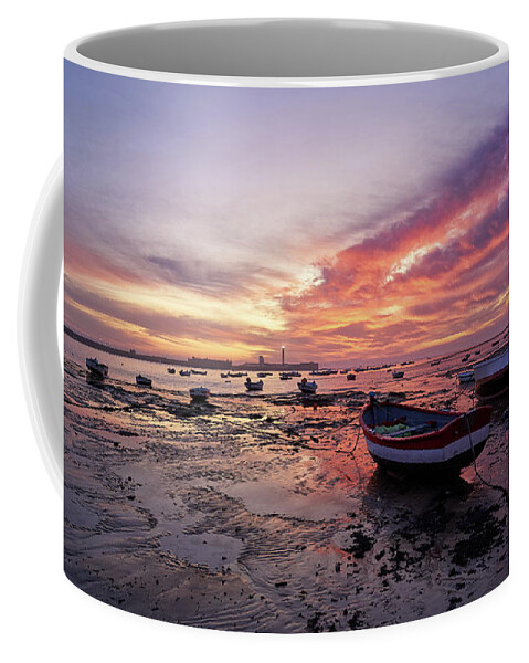 Shore Coffee Mug featuring the photograph Boats at La Caleta Beach at Dusk under a Fiery Sky Cadiz by Pablo Avanzini