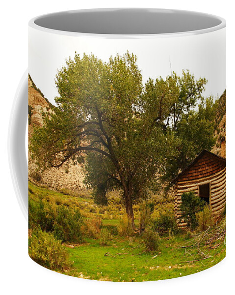 Cabin Coffee Mug featuring the photograph Cabin next to a tree by Jeff Swan