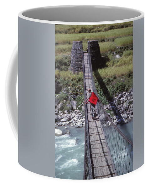 Nepal Coffee Mug featuring the photograph Crossing a suspension bridge by Steve Estvanik