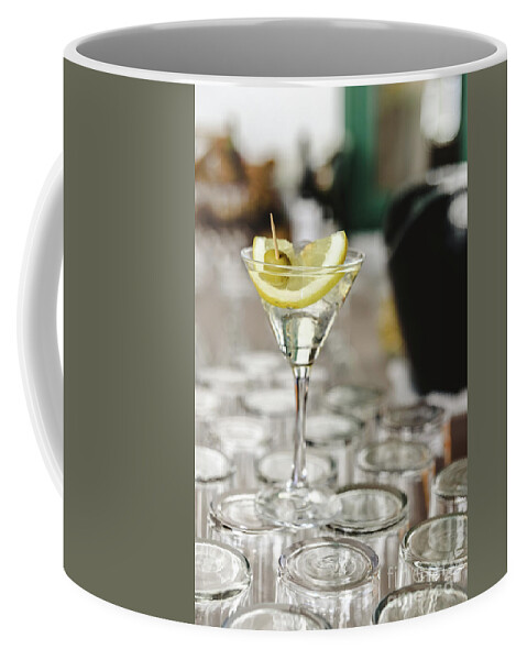 Alcohol Coffee Mug featuring the photograph Cup of gin and tonic, with a slice of lemon and olive. by Joaquin Corbalan
