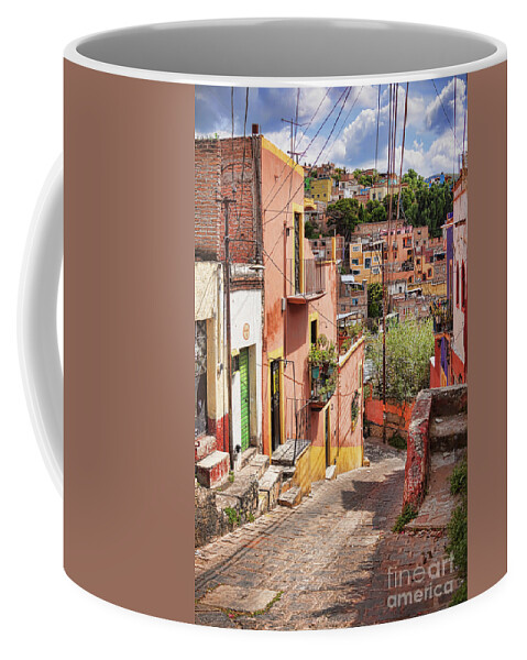 Downhill Coffee Mug featuring the photograph Downhill narrow street in Guanajuato, Mexico by Tatiana Travelways