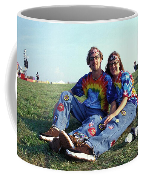 A Young Couple Dressed In Matching Outfits Are Show Relaxing At The Beginning Of Woodstock 99 In Rome Coffee Mug featuring the photograph Matching Outfits at Woodstock 99 by Concert Photos