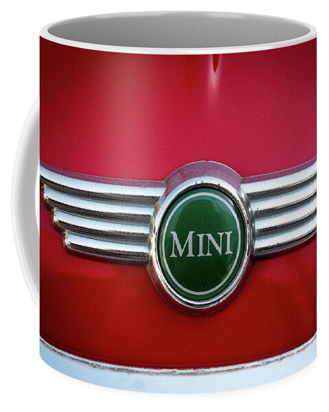 Mini Coffee Mug featuring the photograph Mini Cooper car logo on red surface by Michalakis Ppalis