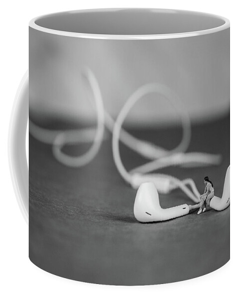 Concept Coffee Mug featuring the photograph Miniature Figure listening to Music and Sitting on Earbuds by Tammy Ray