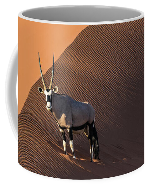 Gemsbok Coffee Mug featuring the photograph Oryx on the edge, Namibia by Lyl Dil Creations