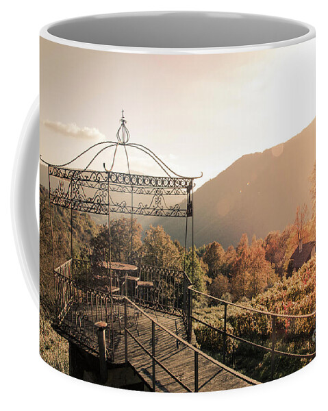 Autumn Coffee Mug featuring the photograph Pavilion in the vineards with table and chairs during sunset by Amanda Mohler