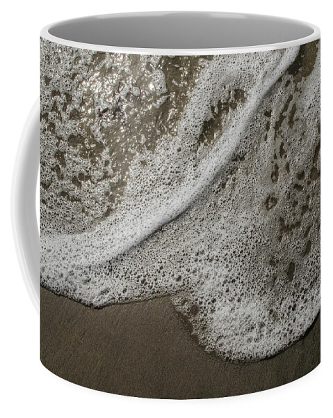 Surf Coffee Mug featuring the photograph Surf Foam On The Sand by Alan Goldberg