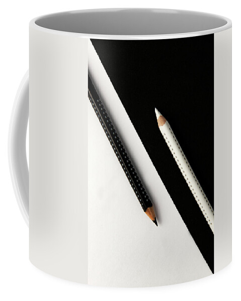 Pencil Coffee Mug featuring the photograph Two drawing pencils on a black and white surface. by Michalakis Ppalis