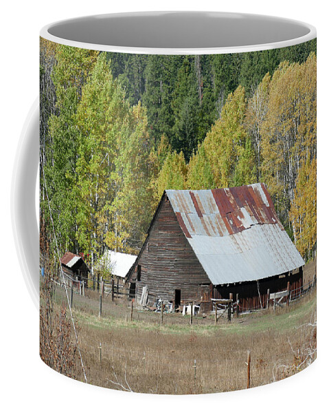 Farm Coffee Mug featuring the photograph Vintage wooden barn with autumn poplars by Steve Estvanik