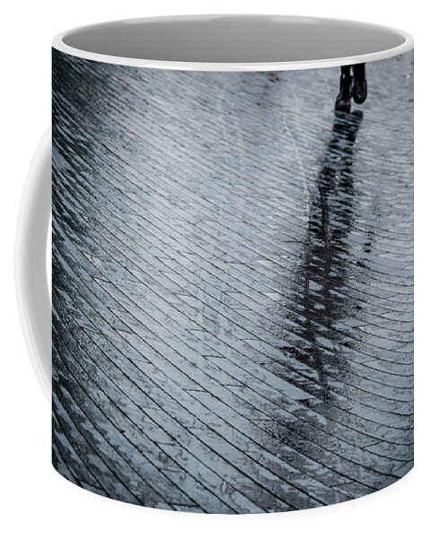 Silhouette Coffee Mug featuring the photograph Walking shadow of an unrecognised person walking on wet streets by Michalakis Ppalis