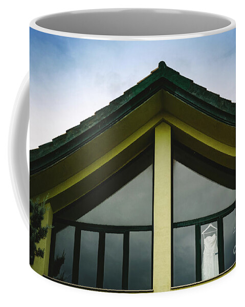 Background Coffee Mug featuring the photograph Wedding dress hanging from a window seen from outside with intense blue sky. by Joaquin Corbalan