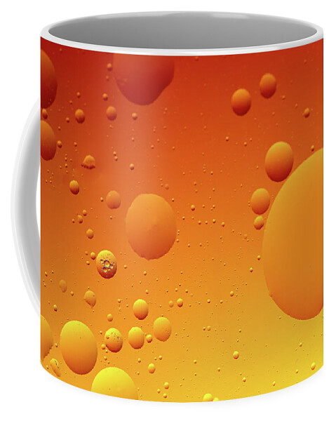 Connection Coffee Mug featuring the photograph Bright abstract, yellow background with flying bubbles by Michalakis Ppalis