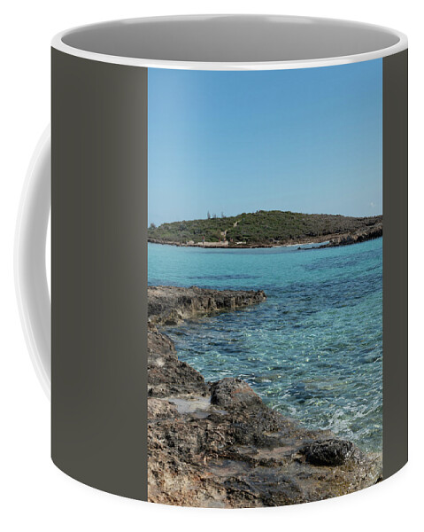 Agia Napa Coffee Mug featuring the photograph Empty beach with blue water at Nissi beach ayia napa Cyprus. Famous tourist resort with clean water by Michalakis Ppalis