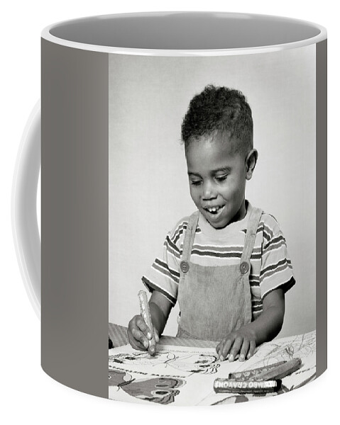 B&w Black And White 1940s 1950s African-american Black Ethnicity Black Boy Busy Cheerful Child Choice Coloring Crayons Creative Direction Discovery Drawing Excitement Expression Fat Fun Future Half-length Happy Home Life Humor Indoors Joy Juvenile Kid Laughing Lifestyle Male Person Pleased Portrait Pride Promise Recreation Single Sitting Smiling Strength Stylish Suburban Success Table Toddler Urban Wellness Working Retro Vintage Nostalgia Nostalgic Old Fashioned Old Fashion Old Time Classic Coffee Mug featuring the photograph 1940s 1950s creative smiling African-American boy toddler sitting at table working drawing by Panoramic Images