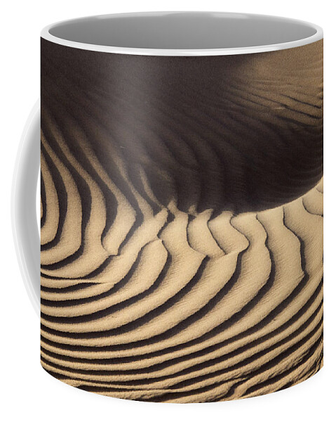 Sand Coffee Mug featuring the photograph Wind blowing over sand dunes #2 by Mikhail Kokhanchikov
