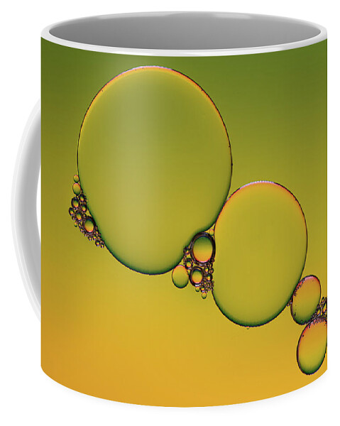 Connection Coffee Mug featuring the photograph Bright abstract, yellow background with flying bubbles by Michalakis Ppalis