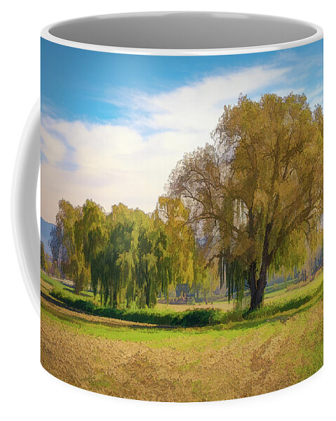 Landscape Coffee Mug featuring the photograph A fainted tree and an oak in the middle of the meadow. by Jordi Carrio Jamila
