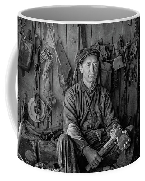 1937 Coffee Mug featuring the photograph A farmer in his toolhouse by David Letts