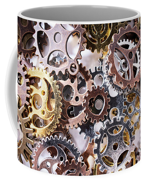 Gears Coffee Mug featuring the photograph A pile of gear wheels and cogs by Mendelex Photography