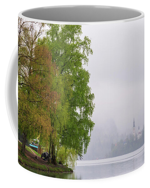Slovenia Coffee Mug featuring the photograph A rainy day in Bled, Slovenia by Mirko Chessari