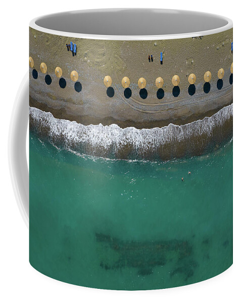  Beach Coffee Mug featuring the photograph Aerial view from a flying drone of beach umbrellas in a row on a by Michalakis Ppalis