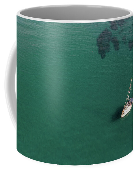 Anchored Coffee Mug featuring the photograph Aerial view of a luxury yacht anchored in the surface of the sea. Cyprus vacations by Michalakis Ppalis