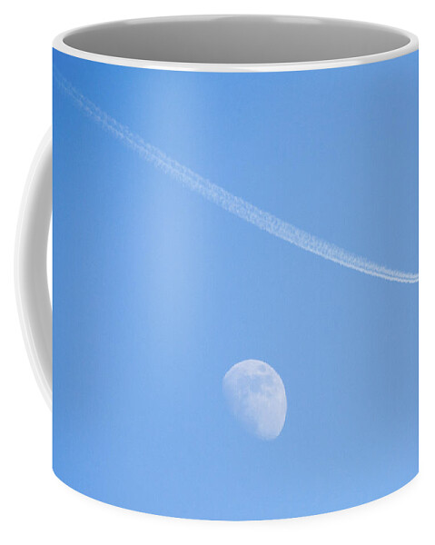 Plane Coffee Mug featuring the photograph Aircraft flying over moon leaving vapour trail during the day, S by Ian Middleton