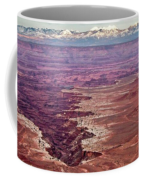 Landscape Coffee Mug featuring the photograph A great crack in the earth in the Canyonlandsf a branch. by Loren Gilbert