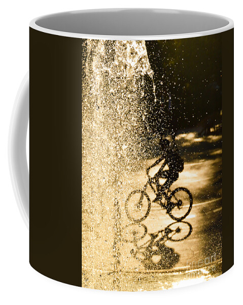 Silhouette Coffee Mug featuring the photograph The bike rider in the water by Yavor Mihaylov